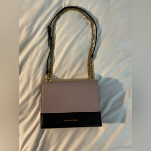 Purple Charles and Keith cross body bad with gold details